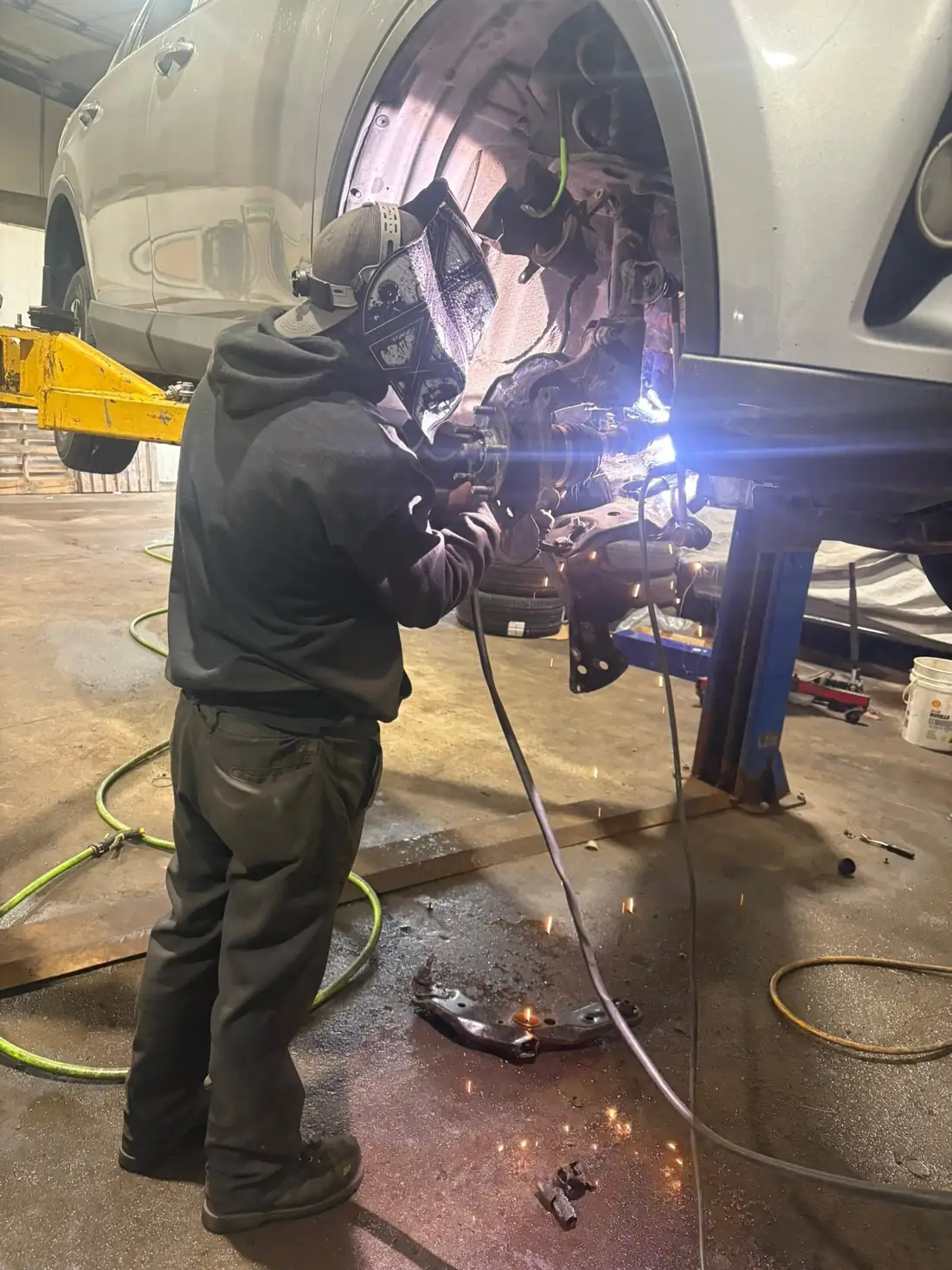 AutoNorth technician welding a suspension repair in the North Bay shop