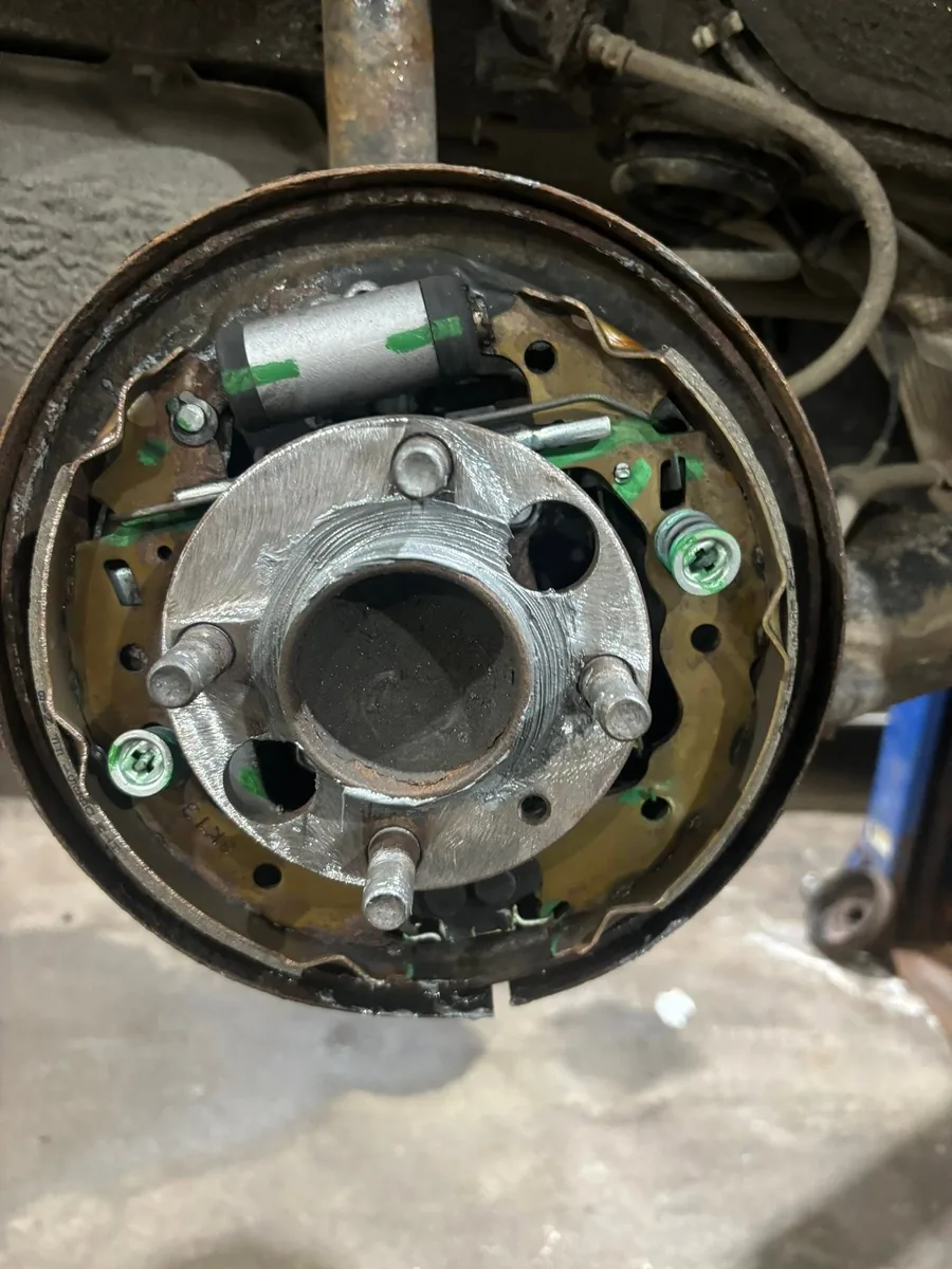 Rear drum brake opened up showing the backing plate, wheel cylinder and hardware, at AutoNorth Auto Repair in North Bay
