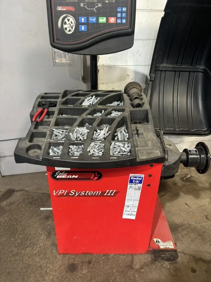 Wheel balancer and tray of wheel weights in the AutoNorth shop in North Bay